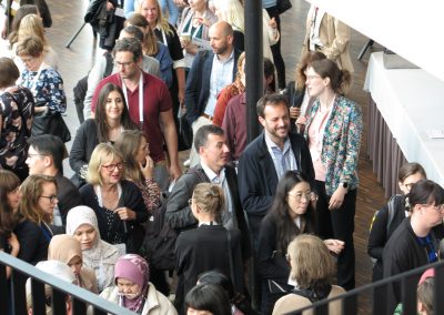 Congress participants, seen from above, mingling between sessions in Aula Medica.